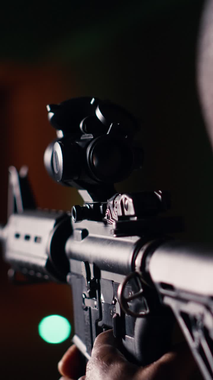 Vertical video Shooting gallery client hitting targets, extreme close up of rifle
