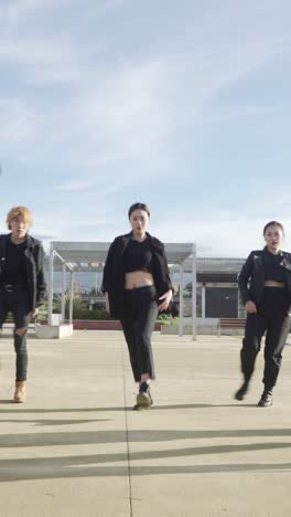young street performer performing on the street. seven chinese teenagers dancing kpop