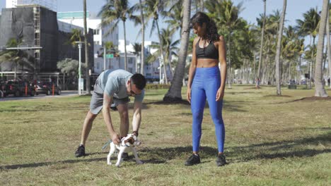 Sporty-couple-with-dog-in-park