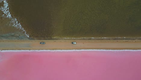 convoy vehicles pulling over point sinclair pink lake near cactus beach, aerial dynamic