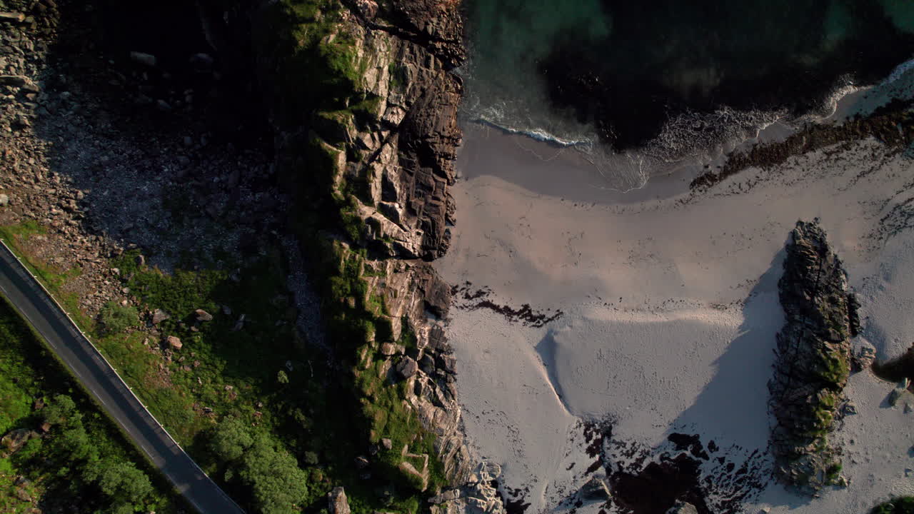 Beautiful sandy beach with contrast between turquoise sea and rocks, Aerial Birdseye shot, Andoya, Vesteralen