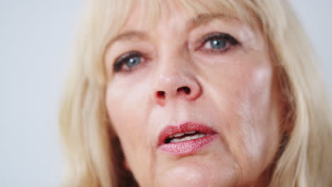 Studio-Shot-Of-Unhappy-And-Frustrated-Mature-Woman-Against-White-Background-At-Camera