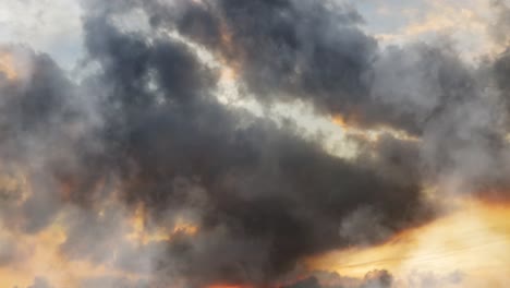 point of view moving closer to dark cumulonimbus clouds at sunset or sunrise