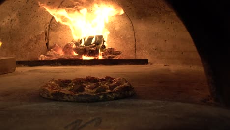 pizza in brick oven slow motion fire