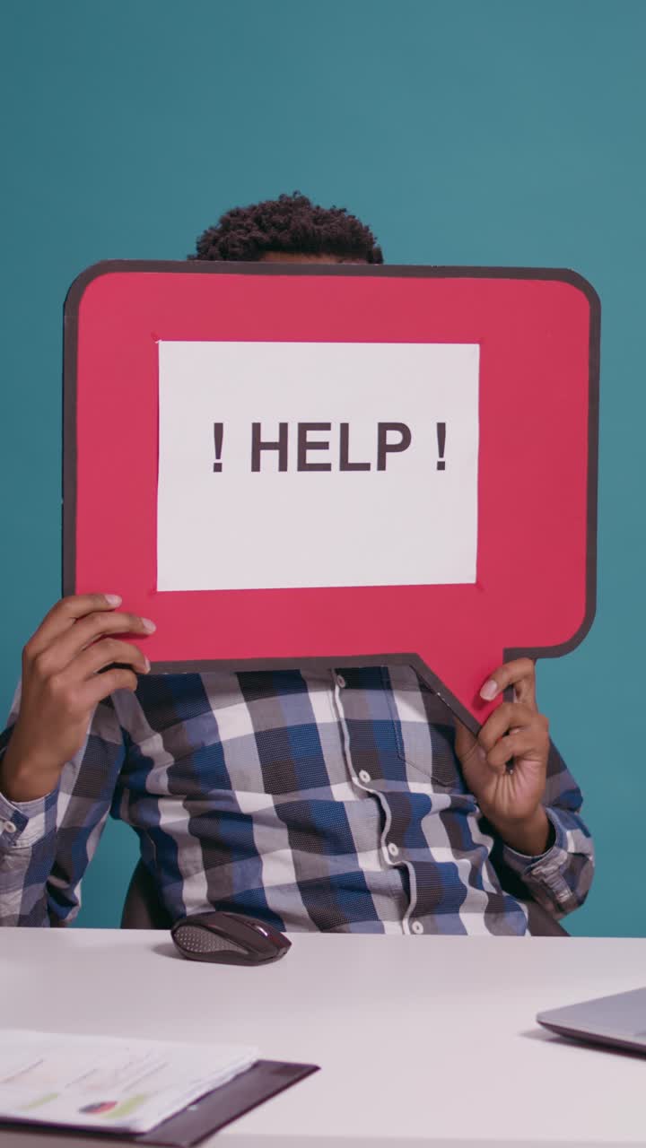 Stressed man in office with help sign