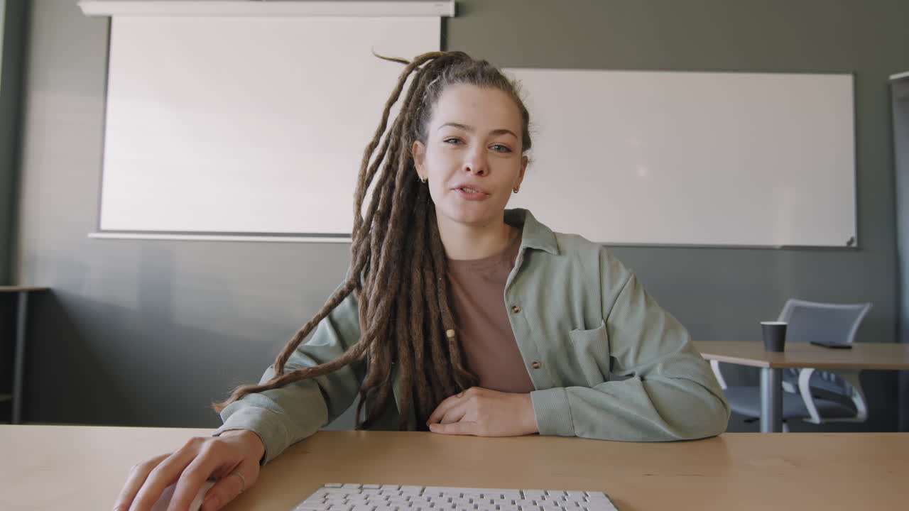 Young Woman with Dreadlocks Talking on Video Call