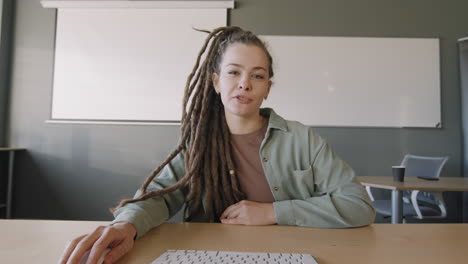 young woman with dreadlocks talking on video call