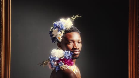 portrait of handsome man adorned with flowers inside classic frame
