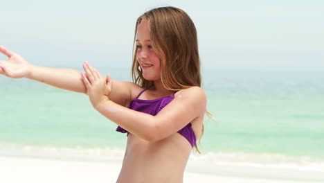 Girl-applying-sun-cream-on-herself