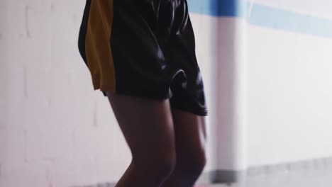 mixed race woman working out in boxing gym