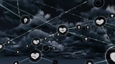 Animation-of-network-of-health-and-idea-icons-exchanging-data-over-cloudy-grey-sky