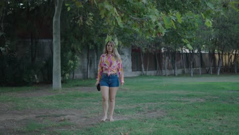 woman walking in a park with coffee