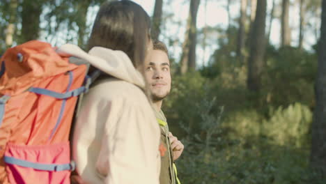 young couple walking in park enjoying fine sunny weather