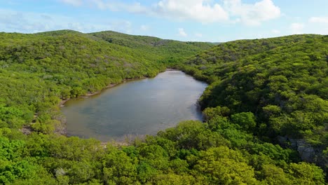 aerial orbit around saltpan lake in westpunt arid mountains in curacao