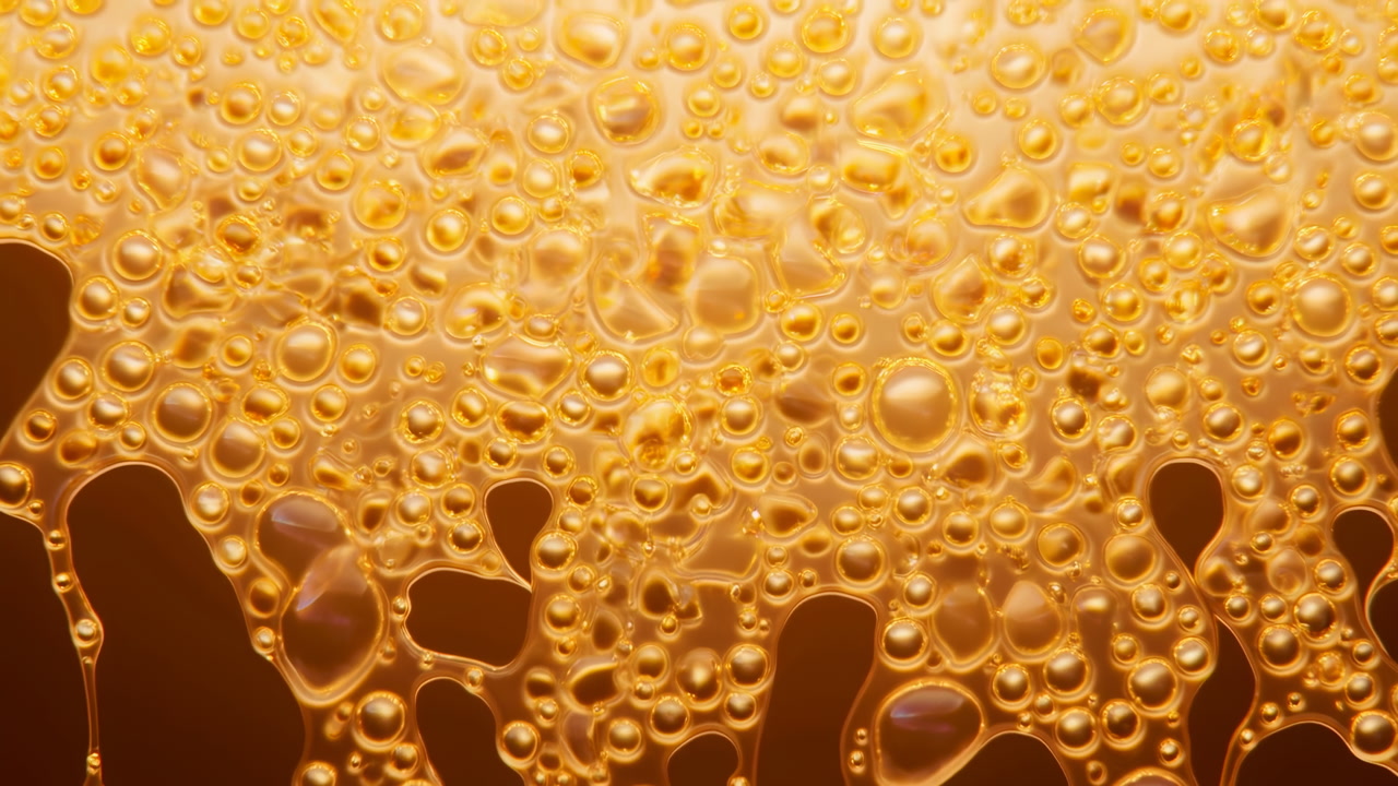 Golden Honey Droplets Macro Closeup, Viscous Amber Liquid Cascading With Dense Bubbles And Dripping Beads