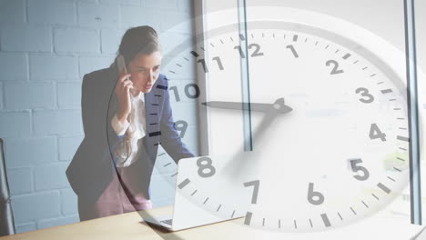 animation of clock moving over caucasian businesswoman talking on smartphone in office