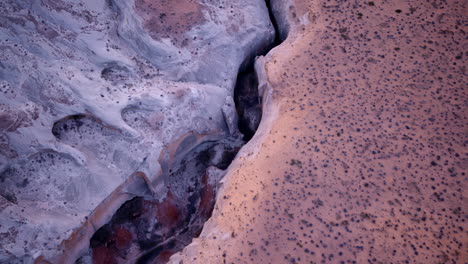 overhead drone footage capturing a slot canyon in the american southwest.