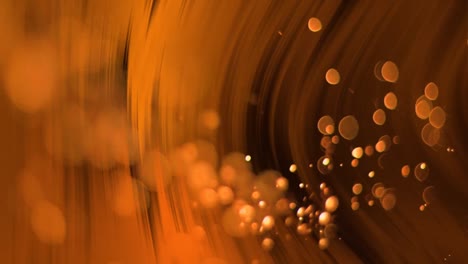 Animation-of-glowing-orange-particles-falling-over-orange-light-moving-on-black-background