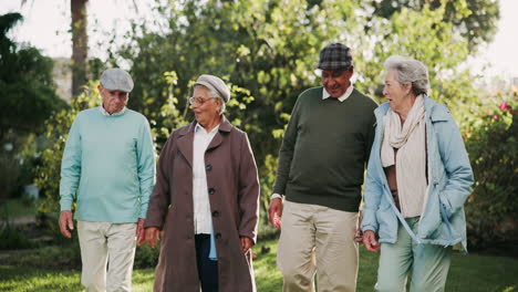 group of elderly people walking in a garden