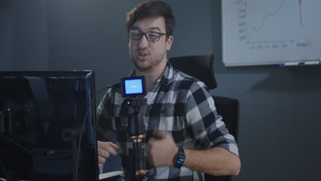man vlogging in office