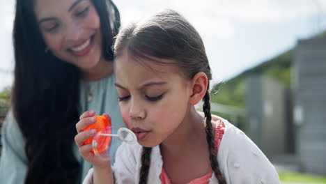 Outdoor,-mom-and-child-blowing-bubbles