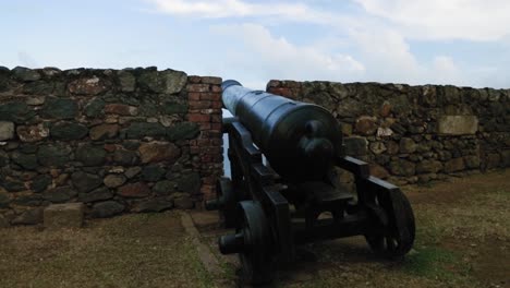 war time canon ready for batte at the wall of fort king george, tobago, west indies