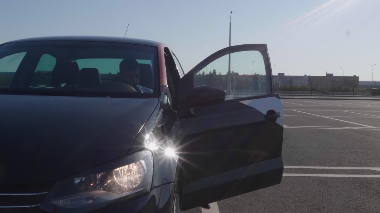 Dark-colored car parked in a parking lot