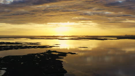 An-aerial-shot-over-Baldwin-Bay-near-Freeport,-NY-at-sunset