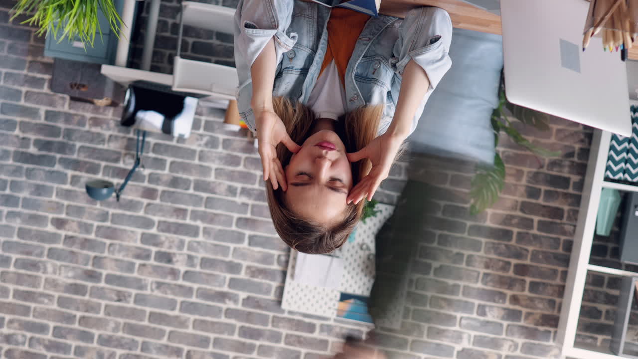 Woman experiencing headache at her desk