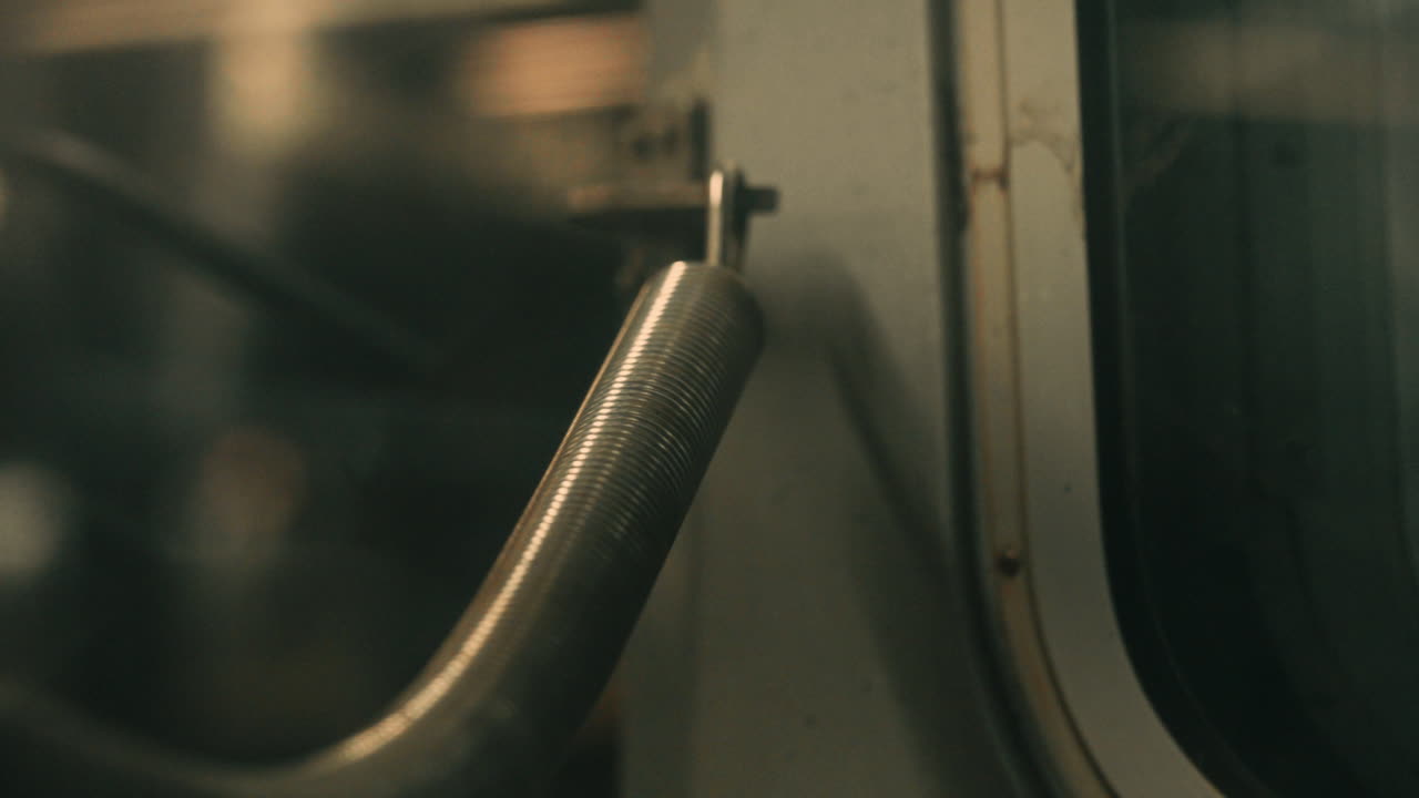 Close-up of Industrial Metal Spring with Light Reflections
