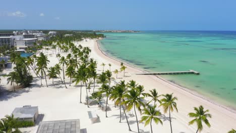 scenic flight at low altitude on the beach of juanillo, seeing the white sand, turquoise blue water and the green palms