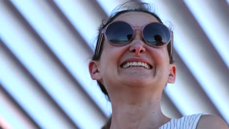 casual happy smiling woman wearing round sunglasses candid laugh