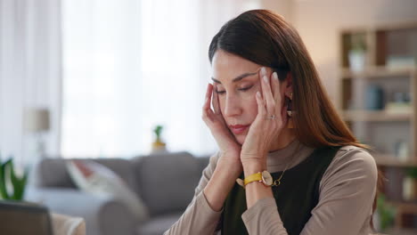 woman with a headache rubbing her temples