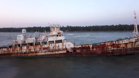 sideway view over wreckage of ship at dusk in kerala, india