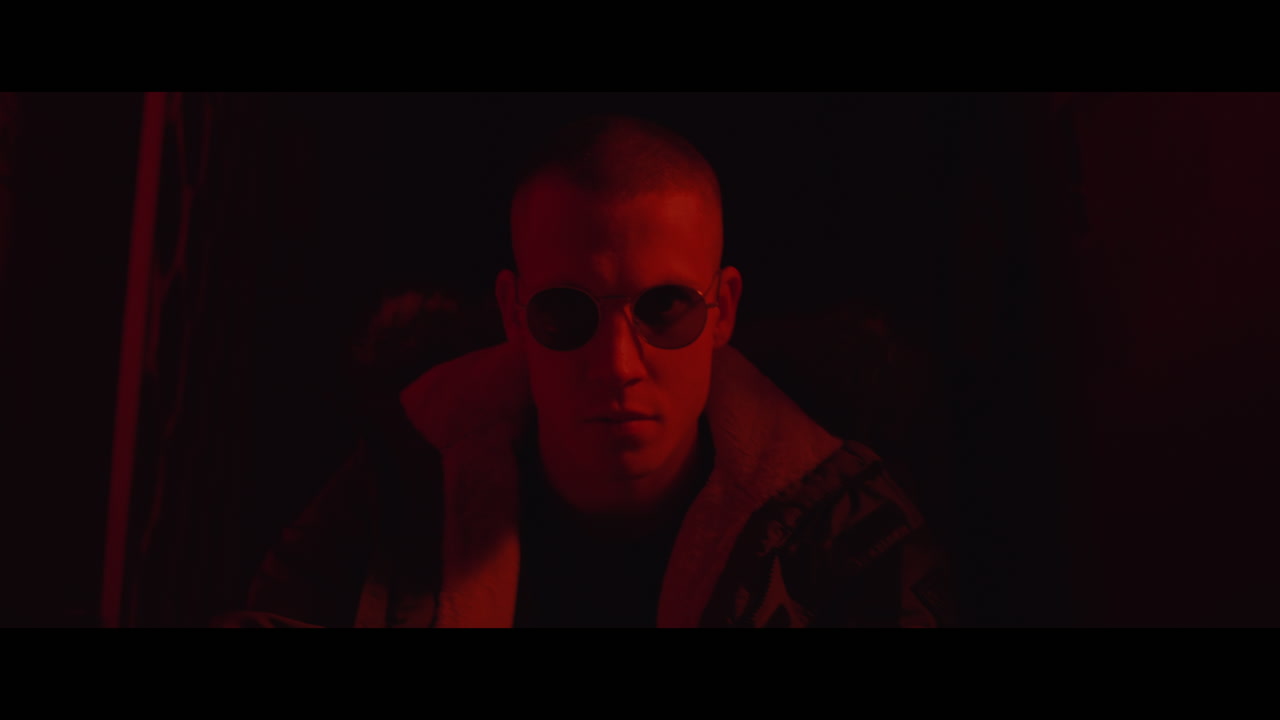 Close-up portrait of a man in red light