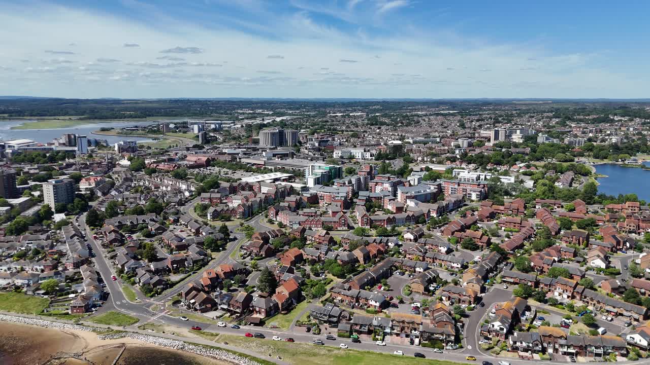 Poole Harbour,drone flight dropping over foreshore at Baiter’s Park and over housing and urban area of central Poole on bright sunny day