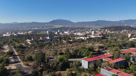 drone rising above southern mexico city with the ajusco mountain range in distance