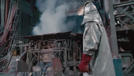 a man standing in a steel manufactory