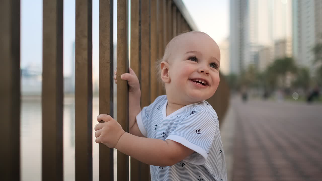 Laughing boy at the age of 1 year dancing.