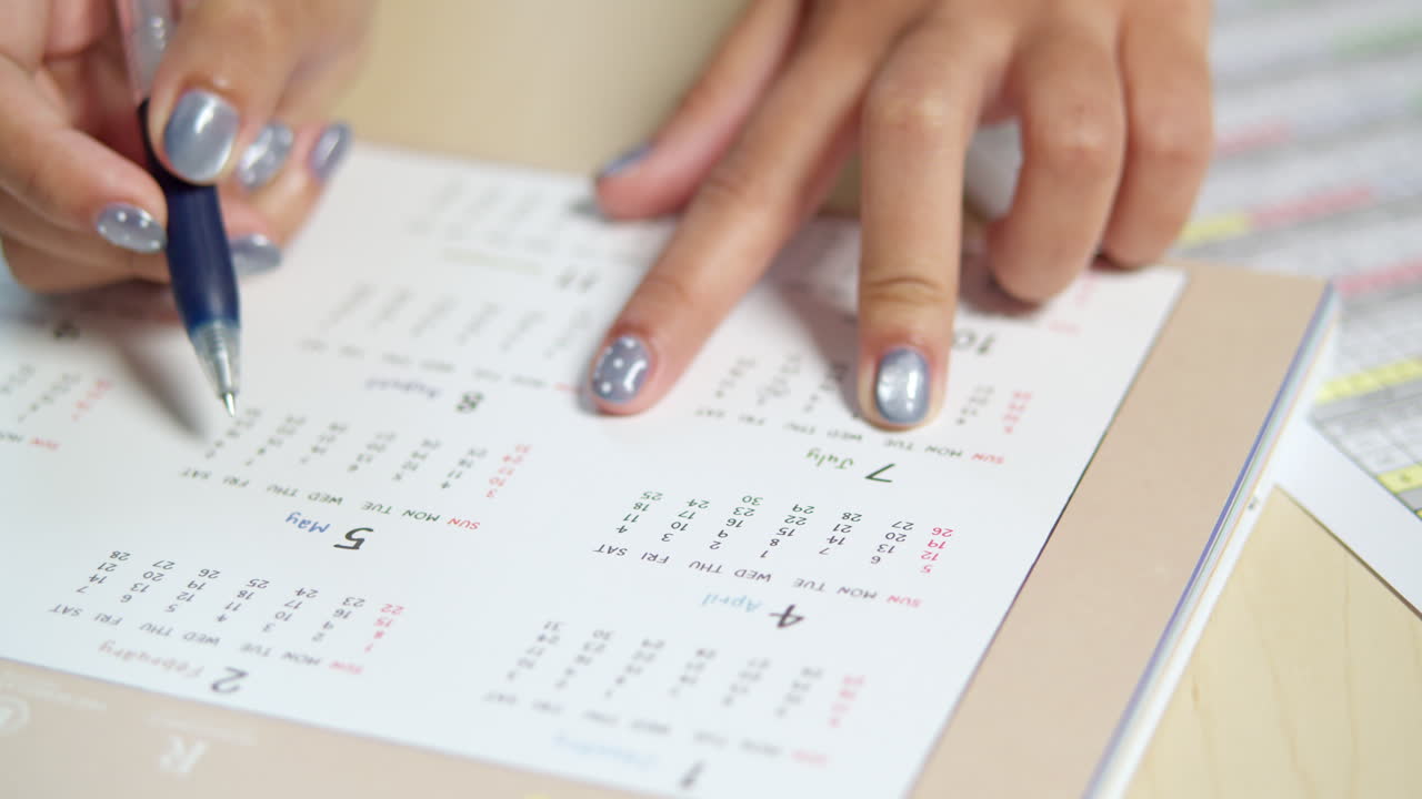 A person meticulously planning an event jotting down crucial details for successful execution