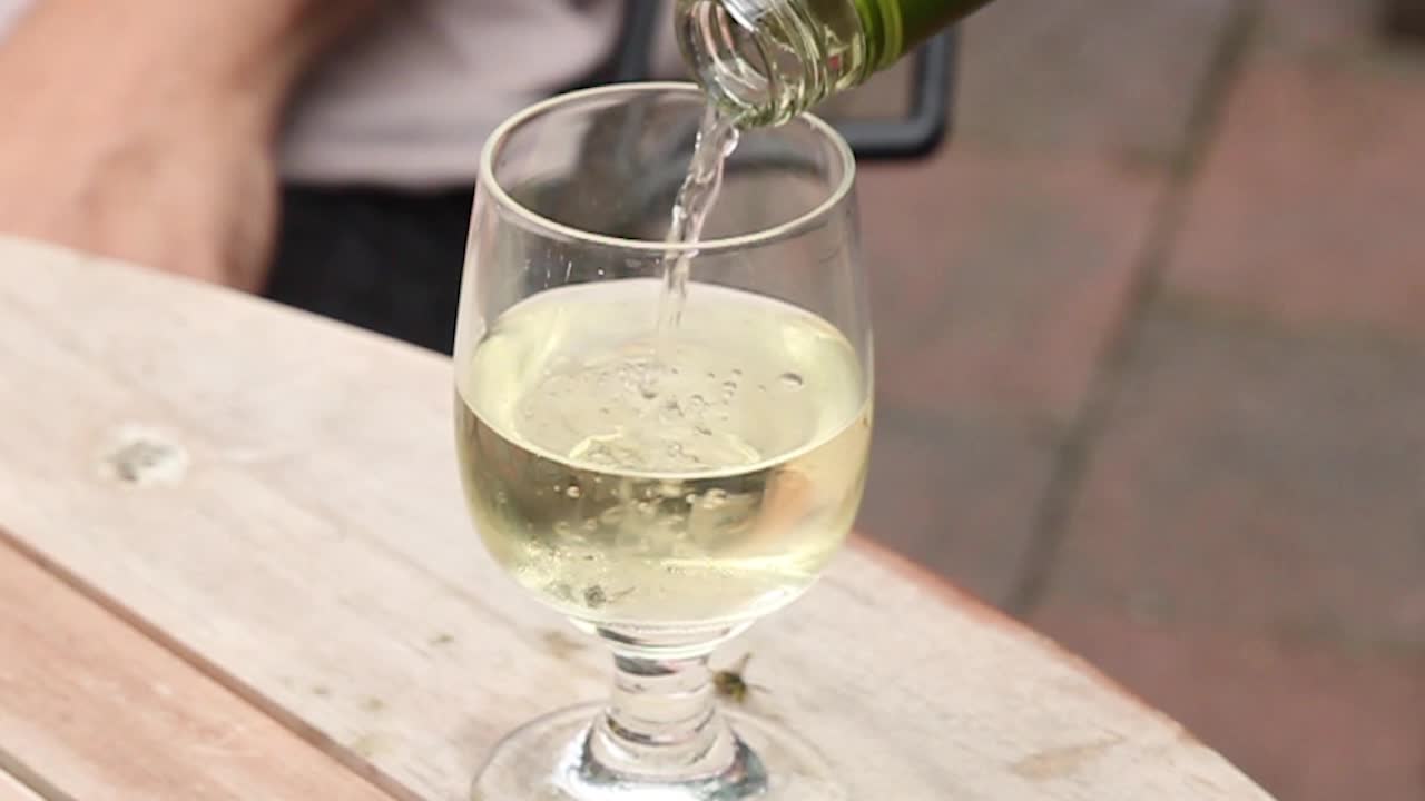Pouring white wine in slow motion