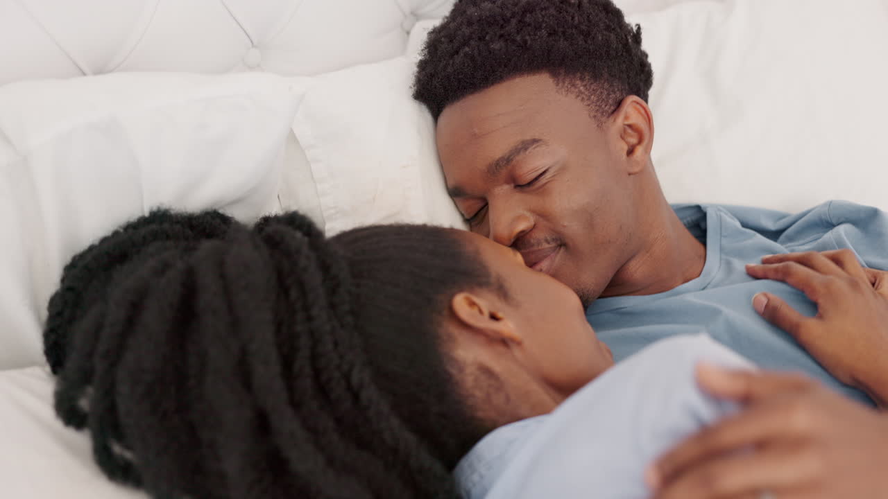 Bed, love and happy black couple romance kiss