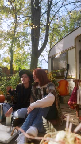 two women enjoying autumn day in campground