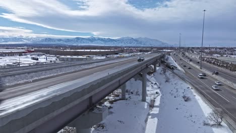 winter traffic on spaghetti bowl interchange overpass in salt lake city, drone