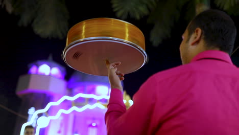 a drum spinning on a man's finger at a popular egyptian wedding