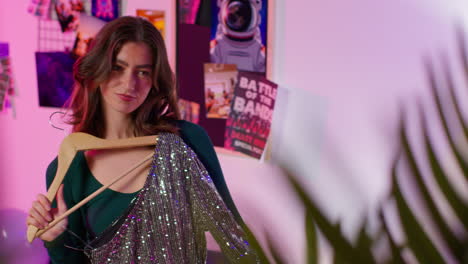 woman trying on a glitter dress in a stylish bedroom