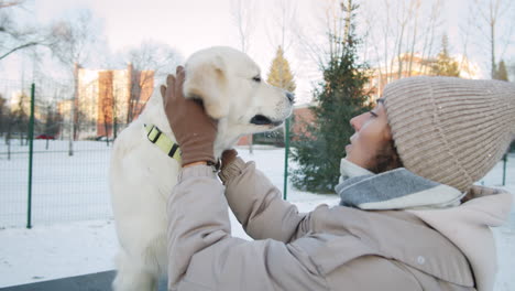 woman and her dog in the park in winter