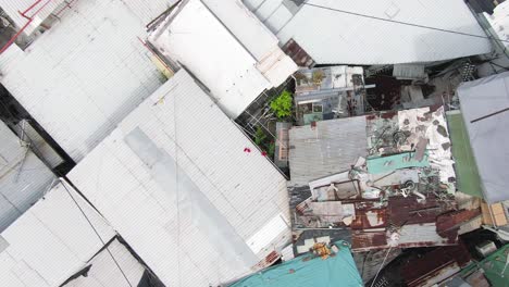 hong kong rundown slum houses populated by squatters, in the outskirts of kowloon bay, top down aerial view