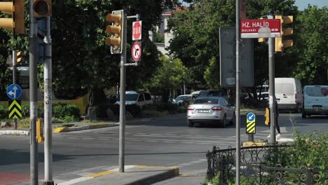 city street intersection with traffic and pedestrians