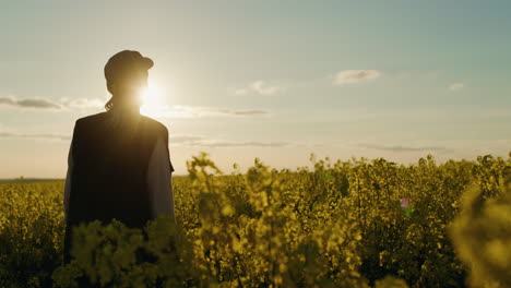 person in a field at sunset